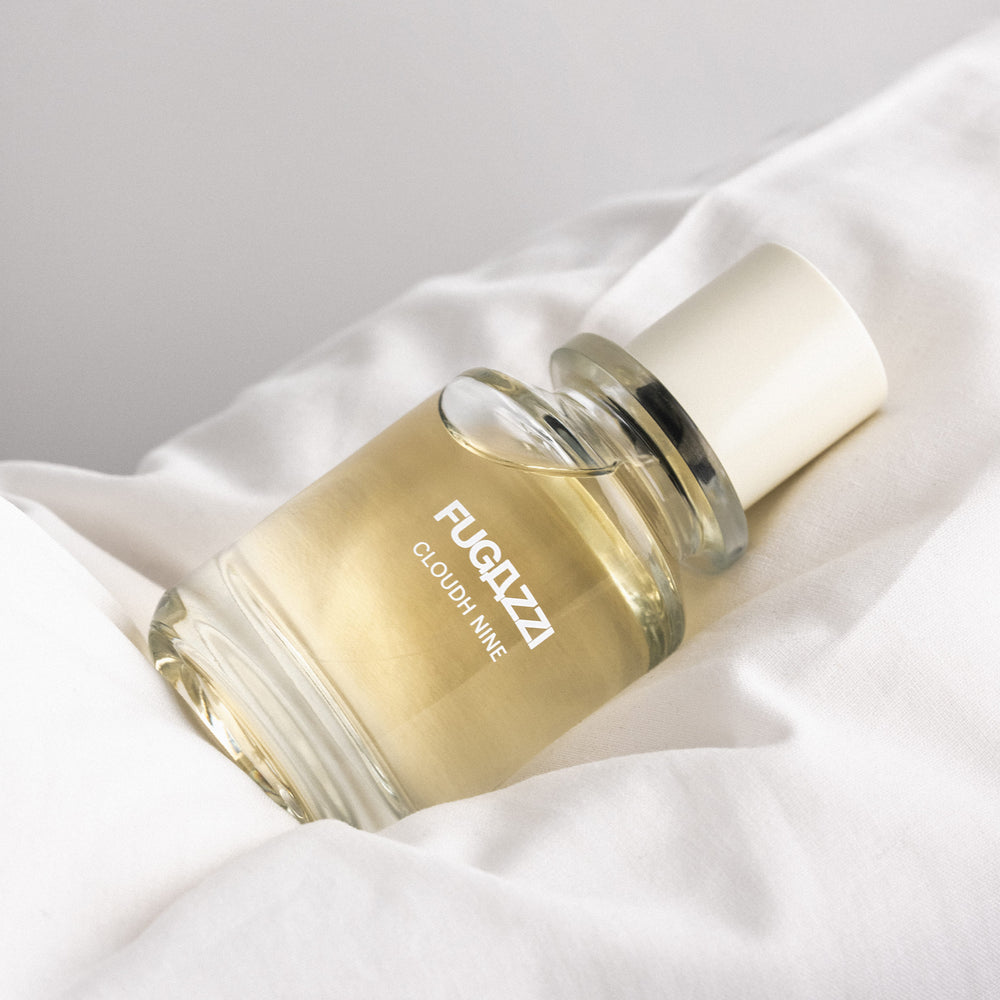 Fugazzi fragrance held against a dark suit