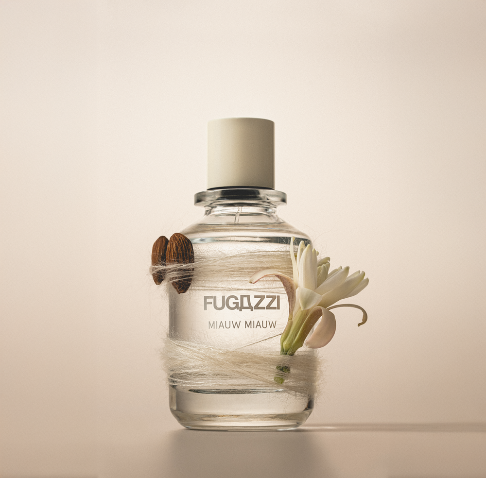 Fugazzi fragrance surrounded by pomegranate seeds