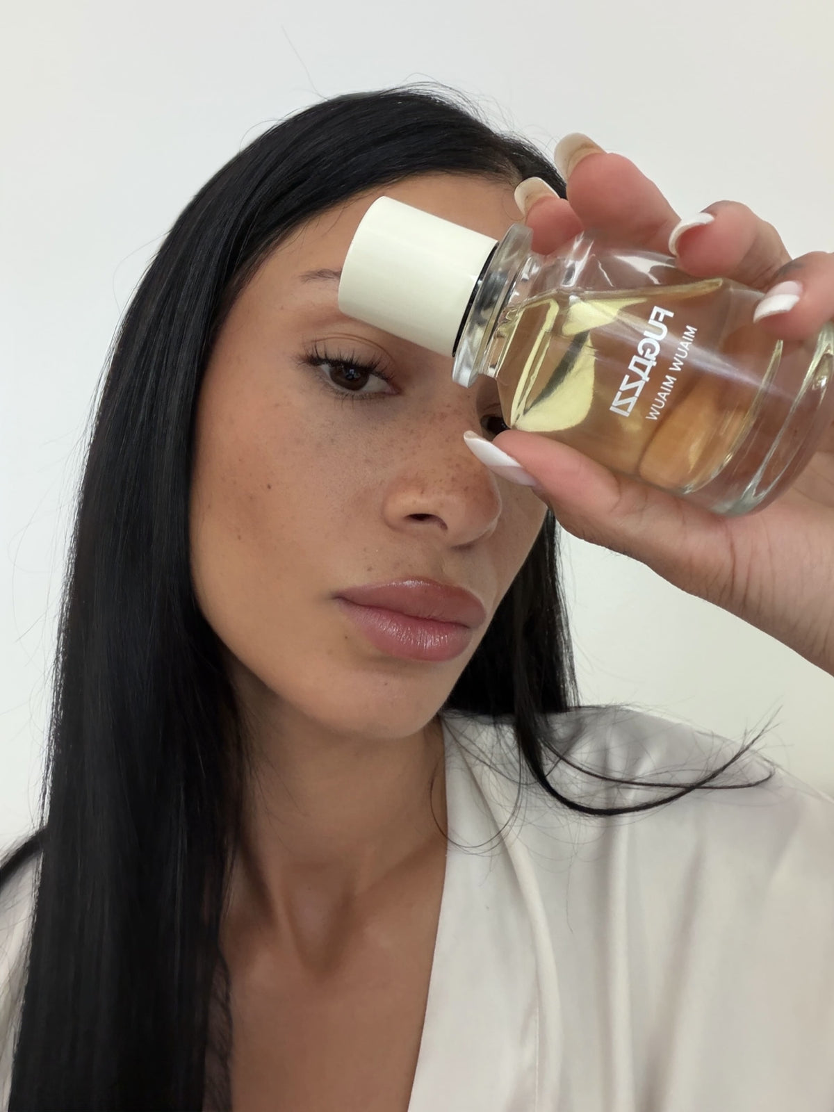 Model holding a Fugazzi fragrance